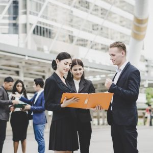 Business coworkers discussing new ideas and brainstorming together looking at new project document.
