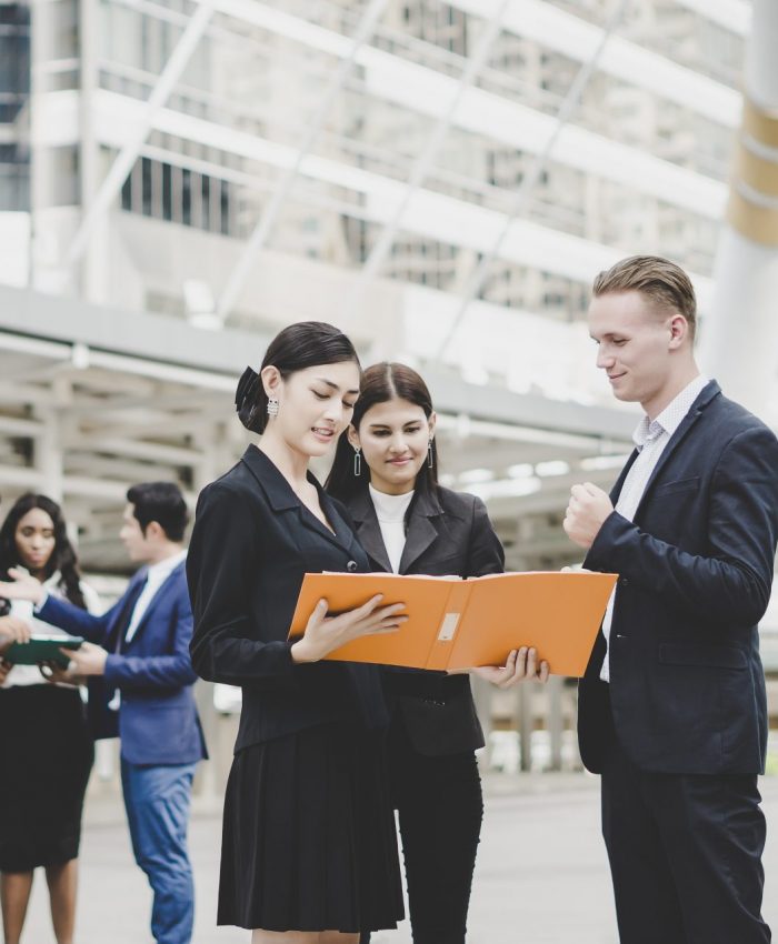 Business coworkers discussing new ideas and brainstorming together looking at new project document.
