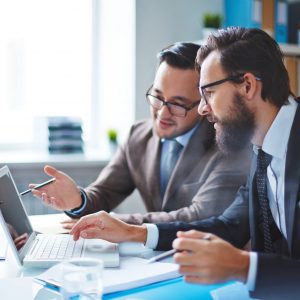 46149384 - two employees discussing electronic data at meeting