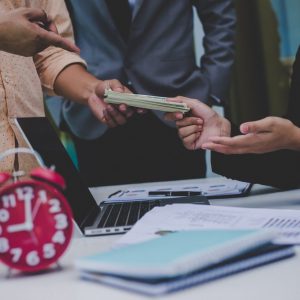 Business partners discussing documents and ideas at meeting. Benefit-sharing, Business success.